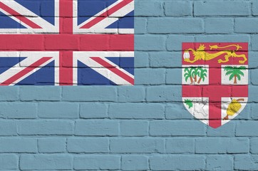 Fiji flag depicted in paint colors on old brick wall. Textured banner on big brick wall masonry...
