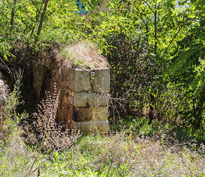 Ruins of old house foundation healed in weeds in willage Valac at Kosovo