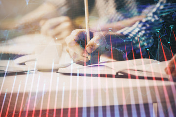 Multi exposure of two men planing investment with stock market forex chart.