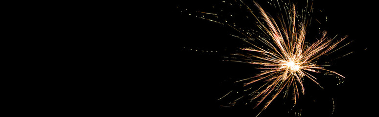 Panoramic shot of orange festive firework on party, isolated on black
