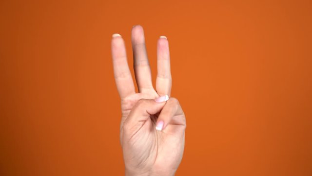 Closeup view of one female hand counting from 0 to 5 using fingers. Real time 4k video footage.