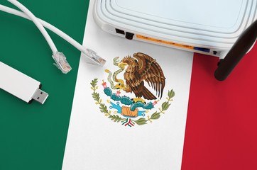 Mexico flag depicted on table with internet rj45 cable, wireless usb wifi adapter and router....