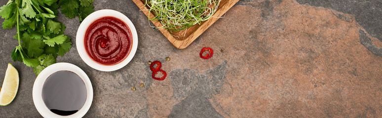 top view of fresh ingredients and sauces on stone surface, panoramic shot