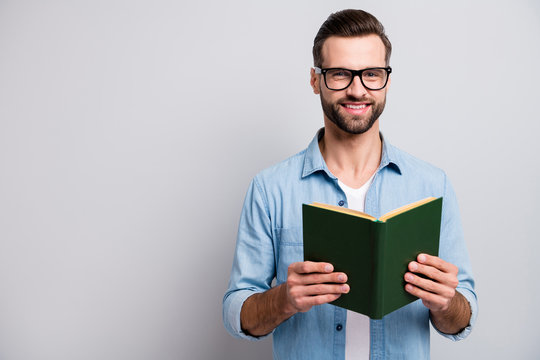 Photo of funny handsome guy holding green book favorite business motivation positive emotions wear specs casual denim clothes isolated grey color background
