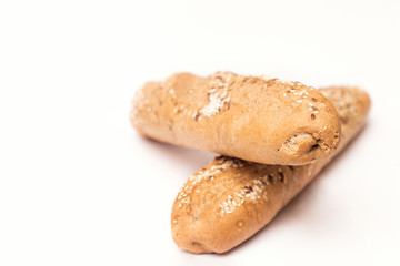 two French baguette with sesame seeds on a white background