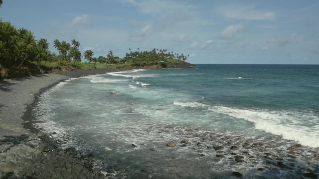 view from balcony of rocky beach waves and palmtrees, São Tomé Island