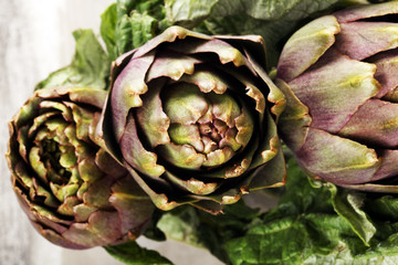 Obraz premium artichokes on grey background. fresh raw organic artichoke flower.