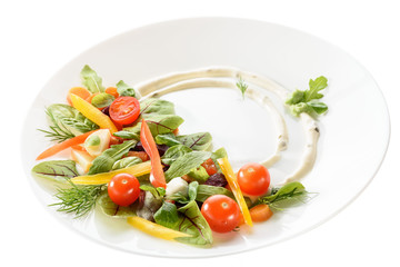 micro-greens and vegetables salad on a white plate