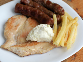 Grilled kebabs with white chicken meat file and French fries wit