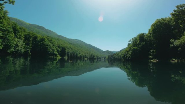 Lake Biograd in Montenegro. Reflection of sky and forest in water. Tourist trip