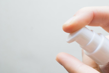 woman hands applying moisturizing cream to her finger skin from a tube. beautiful girl dropping collagen moisturizer serum into her hand at home