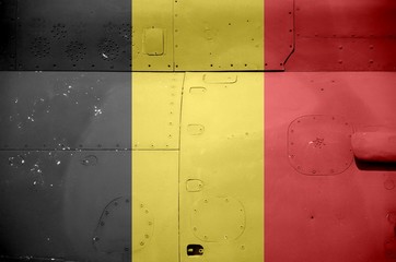 Belgium flag depicted on side part of military armored helicopter closeup. Army forces aircraft...