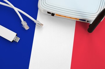 France flag depicted on table with internet rj45 cable, wireless usb wifi adapter and router....