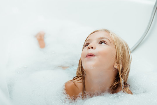 Adorable Naked Child Taking Bath With Bath Foam At Home