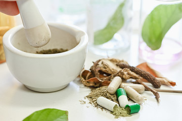 Closeup Herbal medicine making, hand grinding, herbal medicine in mortar