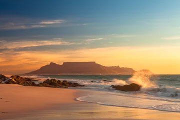 Wall murals Table Mountain scenic view of table mountain cape town south africa from blouberg at golden sunset with splashing waves