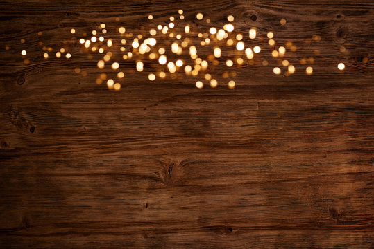 Golden lights on wooden background