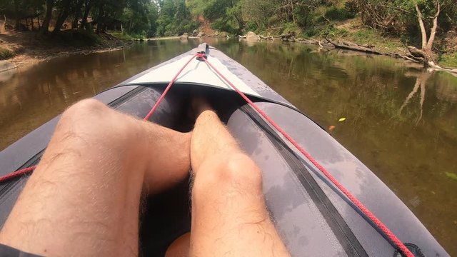 POV of Male Sitting in a Canoe on a Calm Small River in Thailand