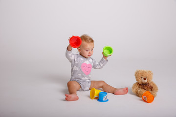 baby girl playing toys isolated white background