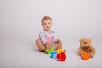 baby girl playing toys isolated white background