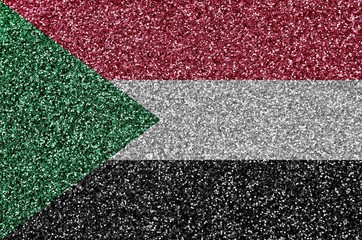 Sudan flag depicted on many small shiny sequins. Colorful festival background for party