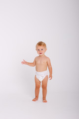 baby girl in a diaper, full-length standing on a white background isolated