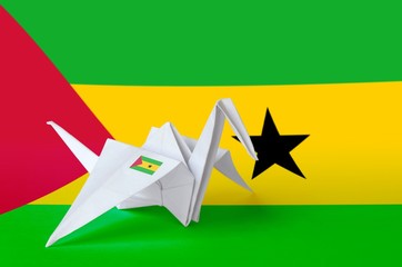 Sao Tome and Principe flag depicted on paper origami crane wing. Handmade arts concept
