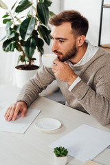 Blind man drinking coffee white reading braille font at table