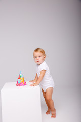 toddler wearing birthday cap on isolated background