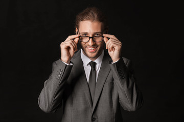 Portrait of handsome businessman on dark background