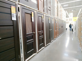 Wooden interior doors are sold in a large building materials supermarket