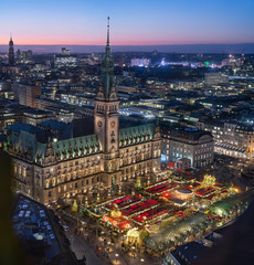 Top view of illuminated Christmas market on townhall square in advent time, Hamburg, Germany
