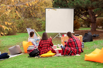 Friends watching movie in outdoor cinema