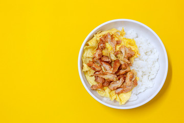 fried chicken and egg and rice on bowl on yellow background