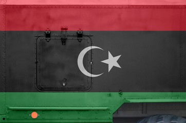 Libya flag depicted on side part of military armored truck closeup. Army forces conceptual...