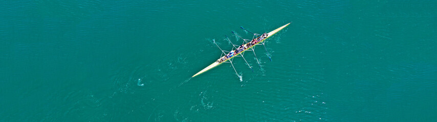 Aerial drone top panoramic view of sport canoe rowing synchronous athletes competing in tropical...