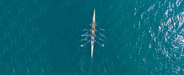 Aerial drone top panoramic view of sport canoe rowing synchronous athletes competing in tropical exotic lake - obrazy, fototapety, plakaty