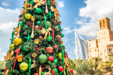 DUBAI, UAE - DECEMBER 9, 2016: Dubai Madinat Jumeirah Christmas Tree and Burj Al Arab