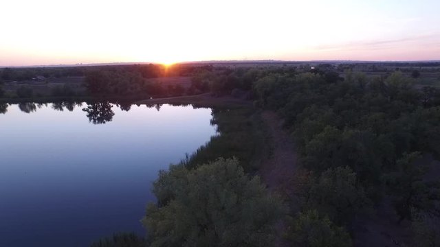 Aerial drone shot flying over the forest valley and river, aerial vew