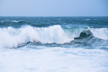 Fototapeta premium The crest of sea waves and white water on a stormy day in the Atlantic Ocean