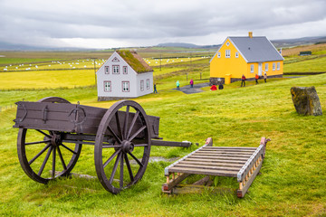 Fototapeta premium Agricultural cart and countryside homes in Iceland