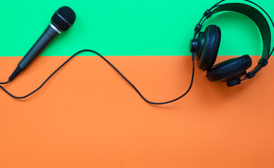 Microphone and headphone on a orange and green background