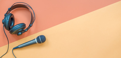 Microphone and headphone on a beige and brown background