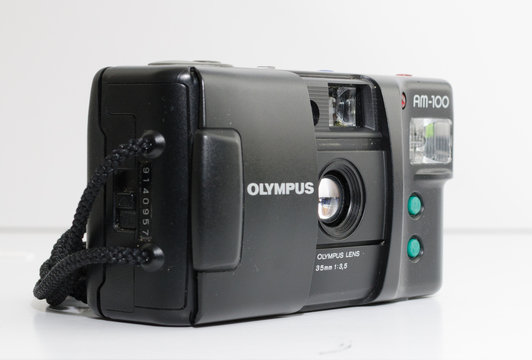 london, england, 05/05/2018 A Retro vintage olympus am 100 35mm camera isolated on a white background. vintage hipster style camera making a fashionable come back in youth culture.