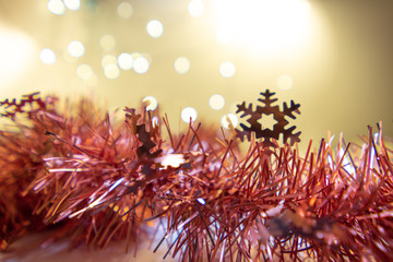Christmas background have fir branches decorated with light bubs. focus at snowflake