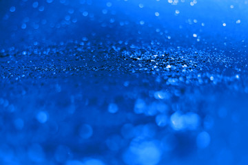 blue glitter sparkle isolated on black background. color 2020