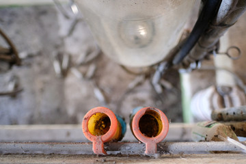 Shallow focus of a pair of rubber milking teats used for connecting to a cow's udder prior to milking. Long since abandoned due to a BSE outbreak, a large milk collection flask in visible. - obrazy, fototapety, plakaty
