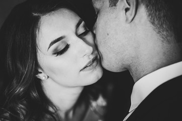 Romantic black and white photo. Man hugs lovingly a tender woman. Young couple in love on...