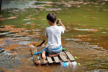 The boy floating on a raft