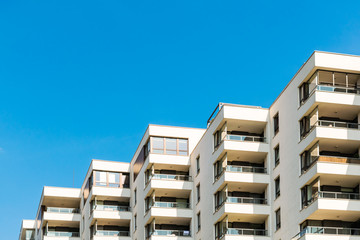 Condominium with corner balconies. Copy space above the building.